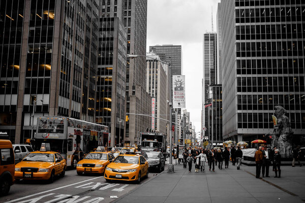 New York City with yellow taxi and walking people