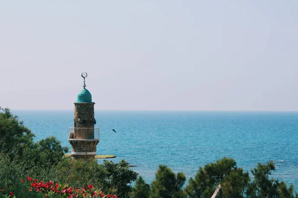 モスクの塔のトップと青い海の水 — ストック写真