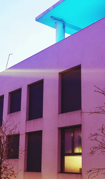 purple modern building facade in sunset