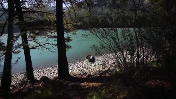 Viejo barco verde de madera está en la orilla de un río de montaña — Vídeo de stock