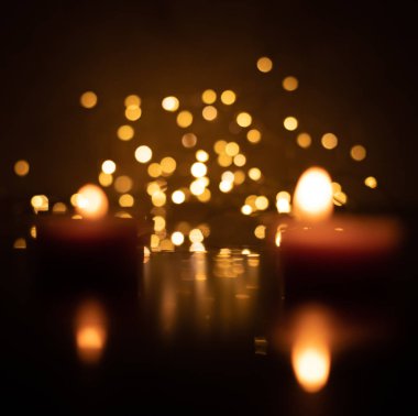 Bokeh of two candles on a background of yellow LED lights