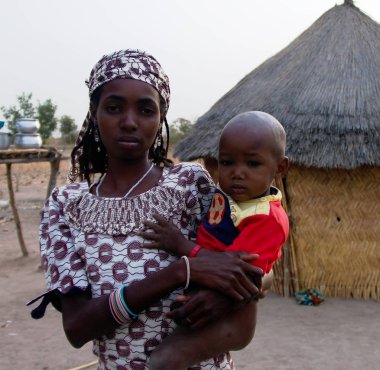 View to fulbe aka fulani tribe woman with child near Tchamba , Cameroon clipart