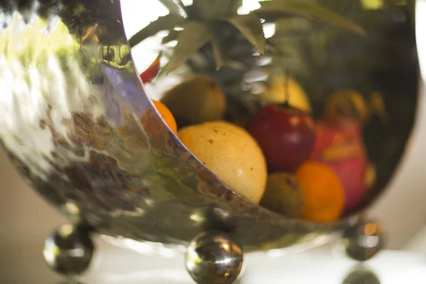 Tropical fruit in a metal vase design. — Stock Photo, Image