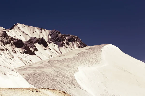Rocky mountain range covered with snow. Retro toning — Stock Photo, Image