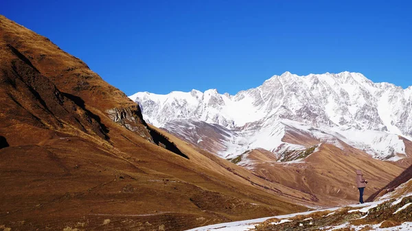 A girl with a camera is shooting. Mountain landscape panorama. — Stock Photo, Image