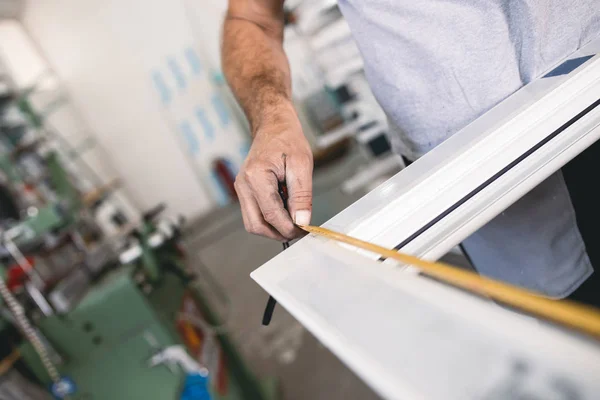 PVC kapıları ve pencereleri monte eden el işçisi