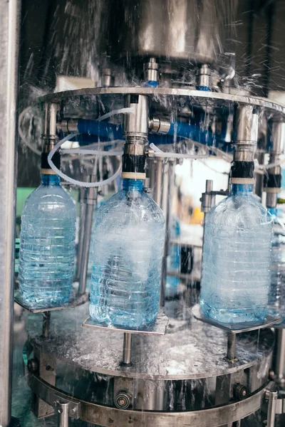 Robotic factory line water bottled into canisters