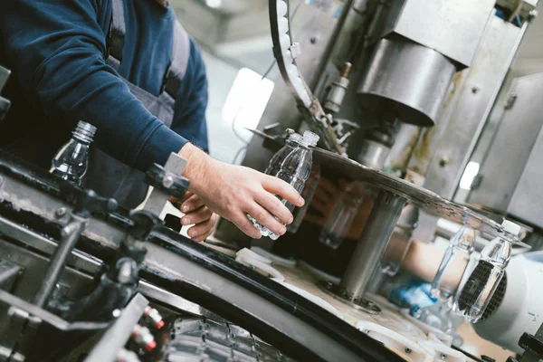 Robotic factory line bottling water into bottles