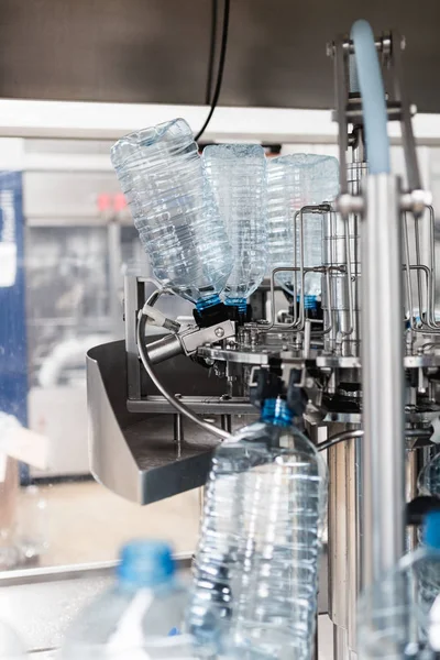 Robotic factory line water bottled into canisters