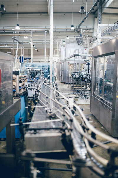 Robotic factory line bottling water into bottles