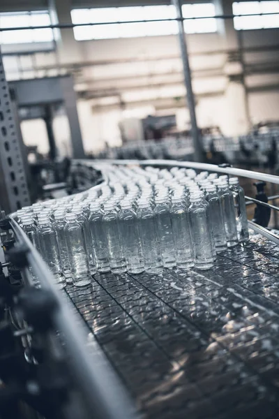 瓶装水装进瓶子的机器人工厂流水线 — 图库照片