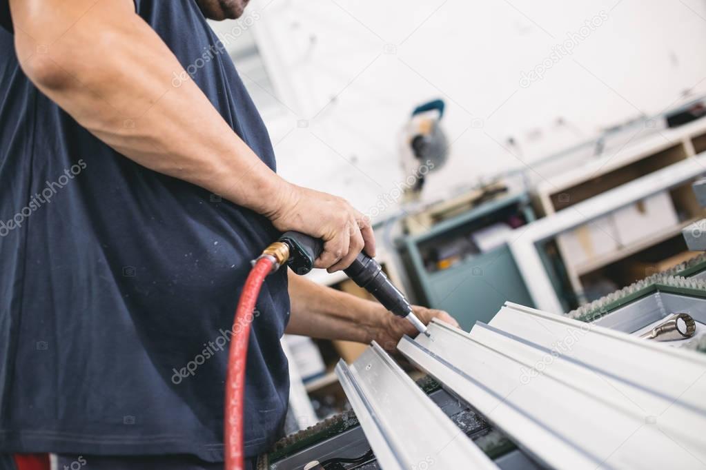 Manual worker assembling PVC doors and windows