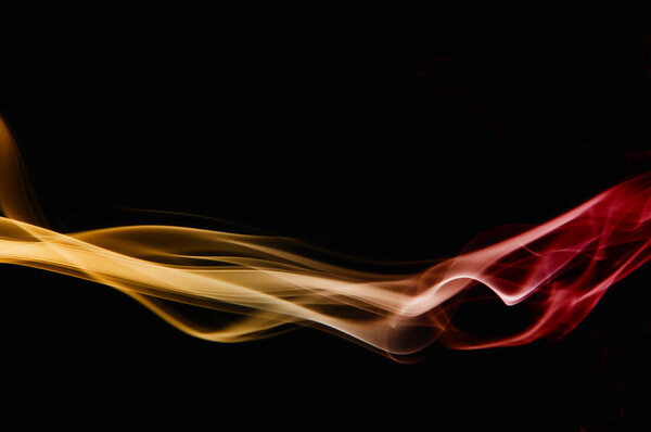 Abstract yellow and red smoke on black background