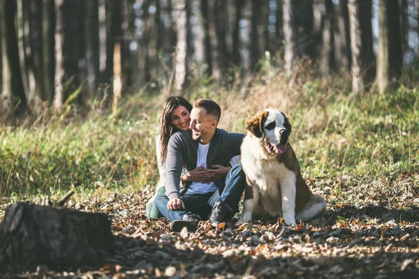 Couple and their dog in forest — Stock Photo, Image