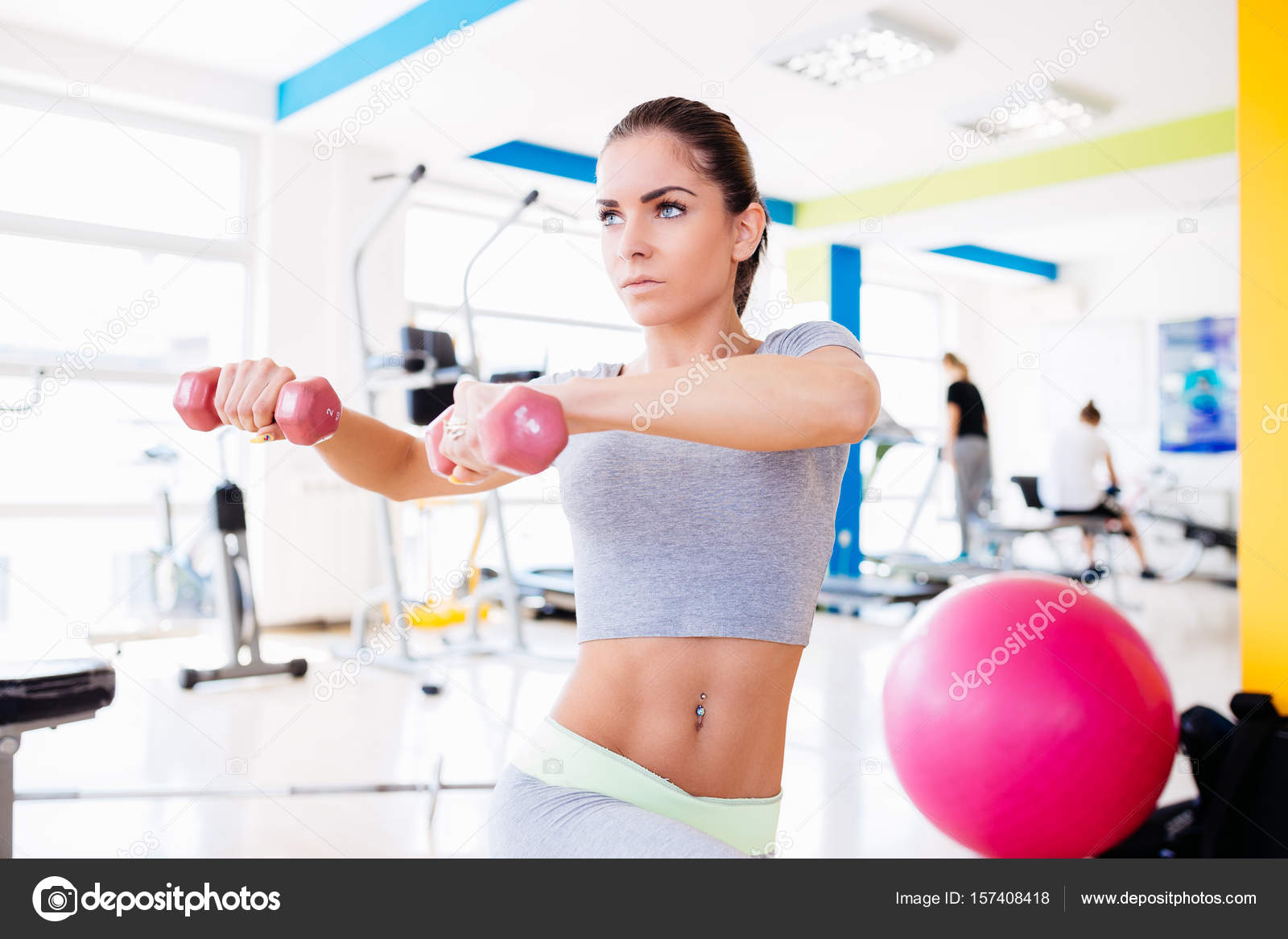 Woman doing exercises at gym Stock Photo by ©DuxX73 157408418