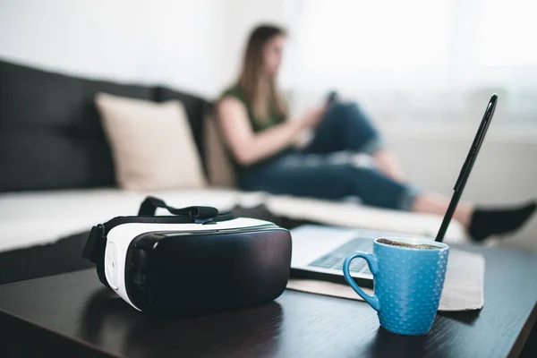 virtual reality headset, cup of coffee