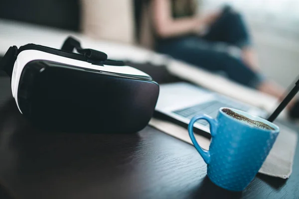 Virtual reality glasses and cup of coffee