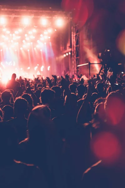 明るいステージ ライトの前で祭コンサートの群集のシルエット 認識できない人々 とカラフルな効果 — ストック写真
