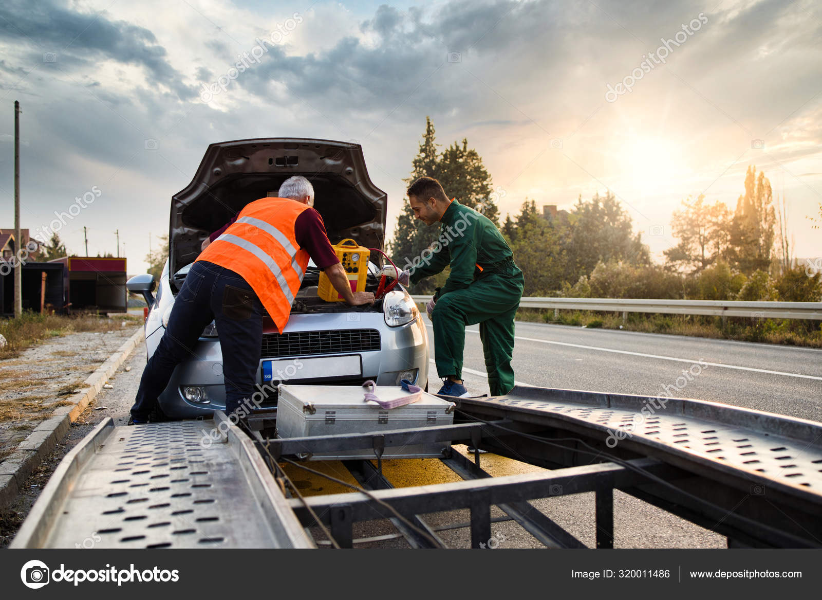 Two Road Assistant Workers Towing Service Trying Start Car Engine Stock