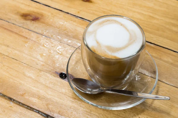 Gros plan Café latte chaud sur fond bois avec saison des pluies — Photo