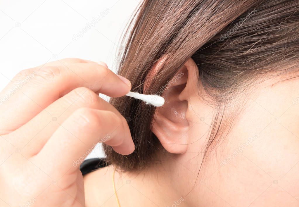Closeup woman cleaning ear with cotton bud, health care concept