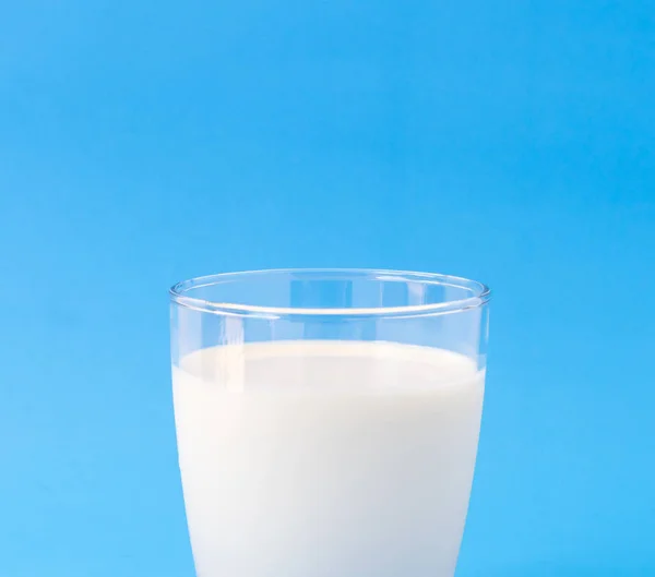 特写镜头杯牛奶在蓝色背景、 食物和饮料的健康概念 — 图库照片