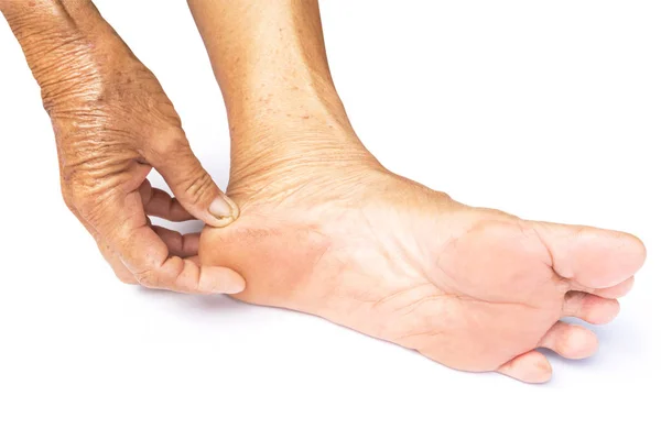 Mão segurando pés mulheres idosas, ter cuidado sentindo com backgr branco — Fotografia de Stock