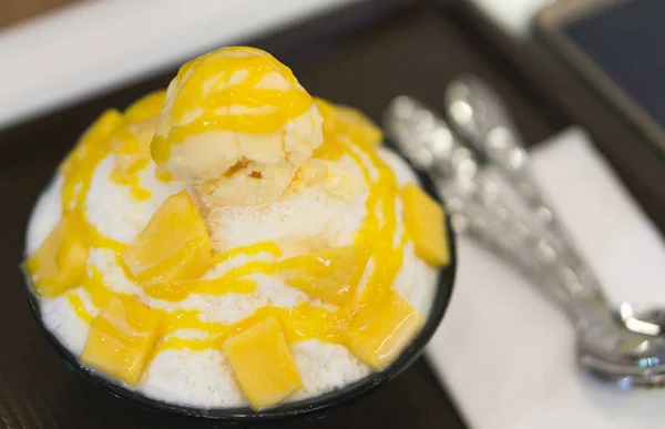 Closeup mango bingsu ice cream korea dessert on table, selective focus