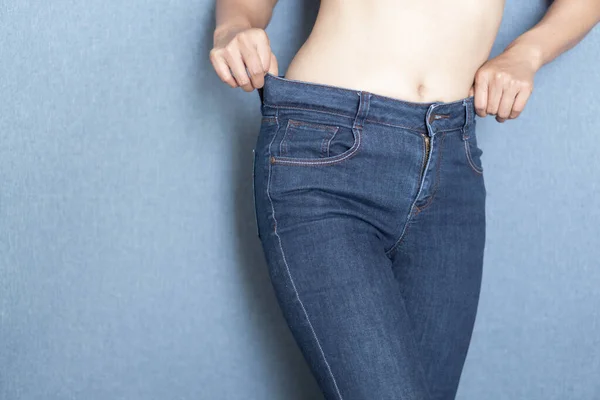 Woman showing jeans pants and body after weight loss and sexy body