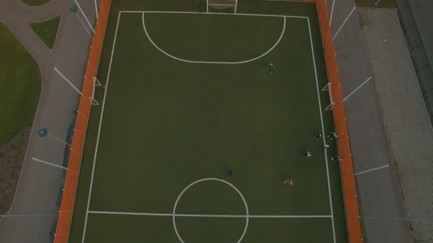 Above top view children play football soccer at school stadium aerial 4K UHD — Stock Video