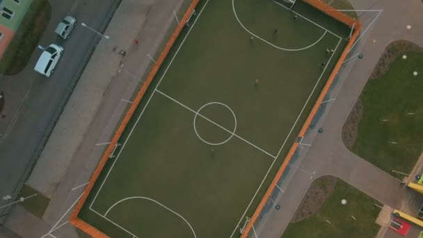 Above top view children play football soccer at school stadium aerial 4K UHD — Stock Video