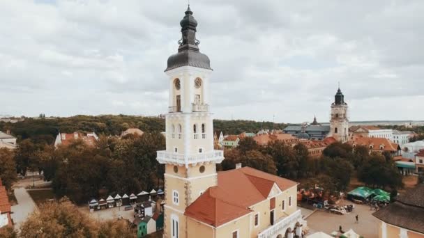 Aerial view of old city center with old houses and town hall. Drone flies over the roofs — Stock Video