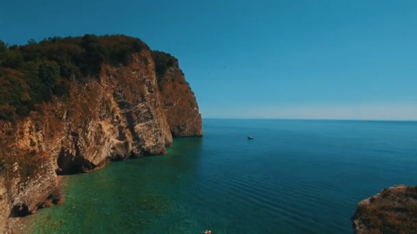 Aerial shot of sea waves and cliff. Sveti Nikola Island rock coast drone footage — Stock Video