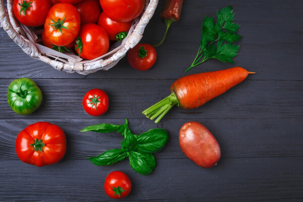 Vegetables and herbs at wooden board