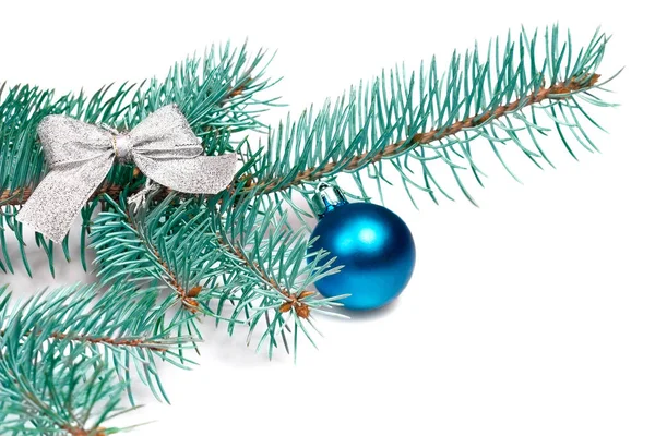 Branch fir from silvery bow and blue ball isolated on white background Royalty Free Stock Photos