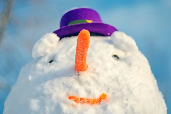 戴紫色帽子的雪人。面部肖像 — 图库照片
