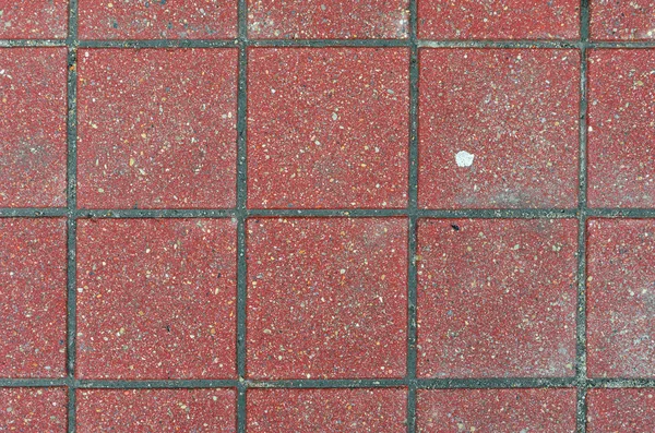 Rött tegel gatsten på en trottoar — Stockfoto