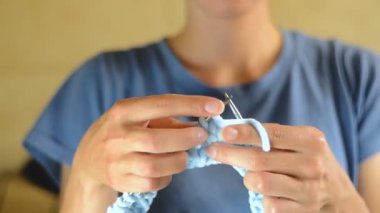 Genç kadın yuvarlak örgü iğneleri ile dokuma kumaşlar