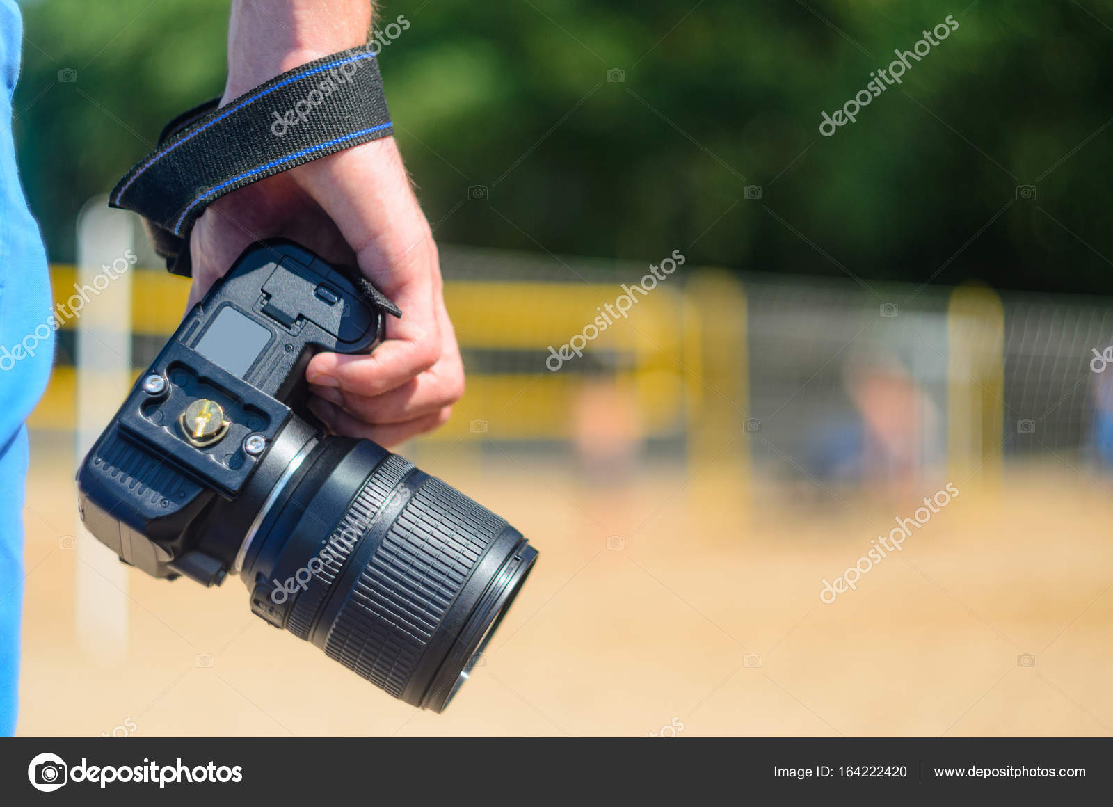 DSLR camera in hand in sea beach background Stock Photo by ©V_Sot 164222420