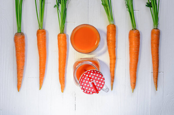 Carrot smoothie in a jar with carrots top view