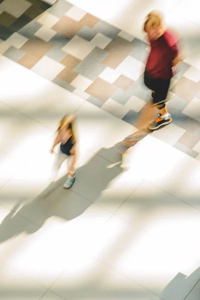 Silhouettes of two walking people