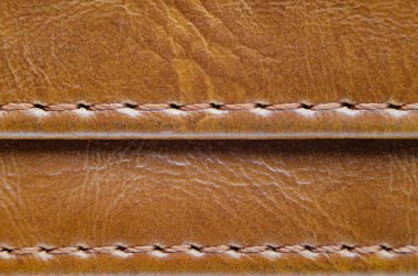 Dikiş ile kahverengi deri dokusuna. Deri giyim yakın çekim unsuru. Dikişleri deri ürünleri