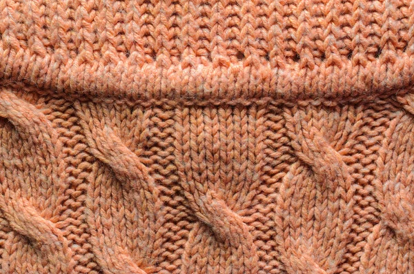 Texture of a Red Color Knitted Sweater. Area Abutting the Collar to a Sweater with Cable Knitted Pattern. Blank Background