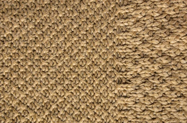 Beige Texture of a Knitted Sweater with Two Types of Knitting. Knit texture as background.