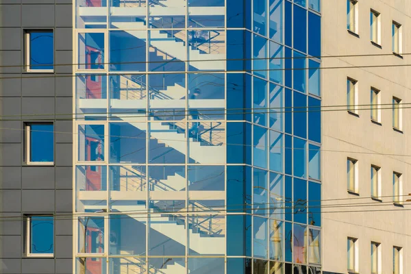 Figure of a Man in the Stairwell of an Office Building Behind a Glass Facade. Staircase with Glass Facade in an Office Building Architecture Background
