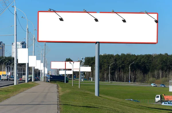 Many blank billboards on the highway at the entrance to the city