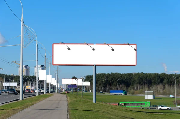 Many blank billboards on the highway at the entrance to the city