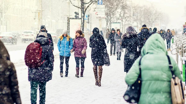 Folk går på en isig snöig trottoar — Stockfoto