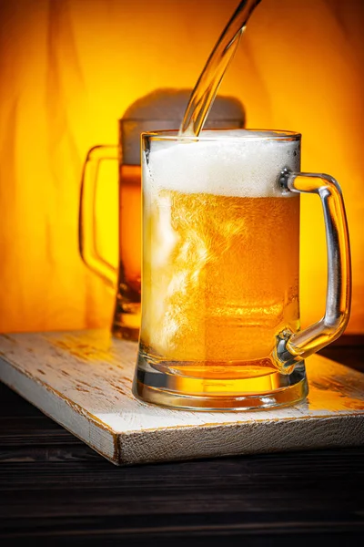 Pour Light Beer into Mugs