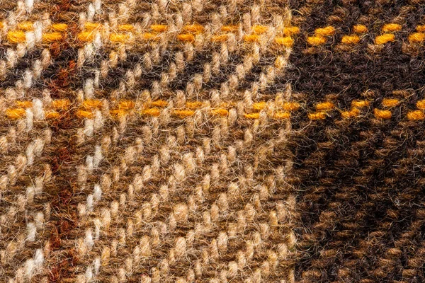 Brown checked fabric. Scottish wool. Close up